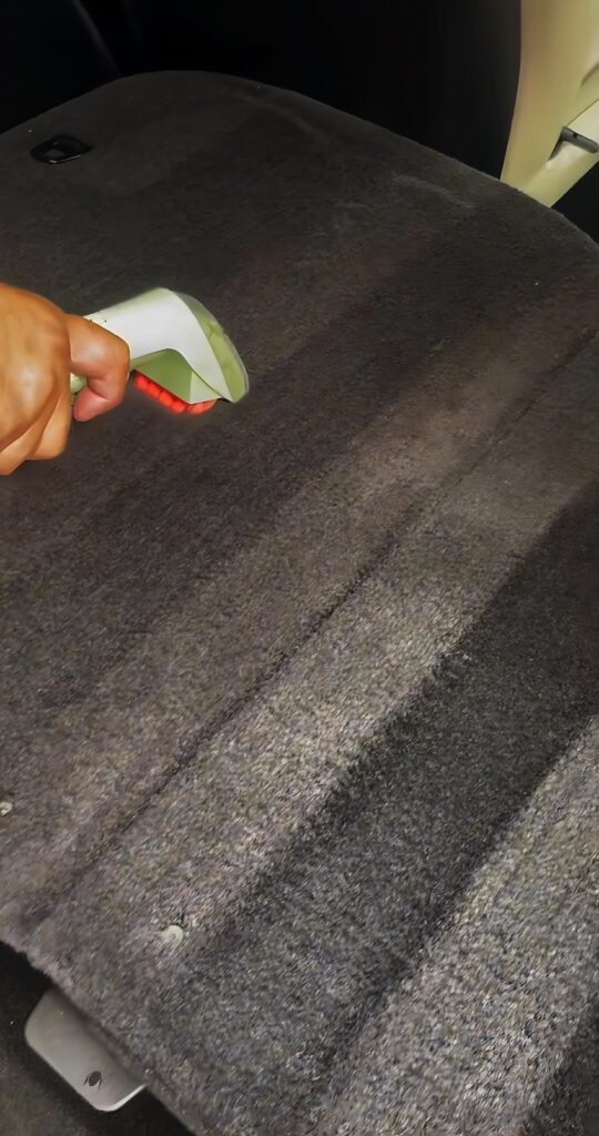 stain in a car carpet being extracted out in Croydon