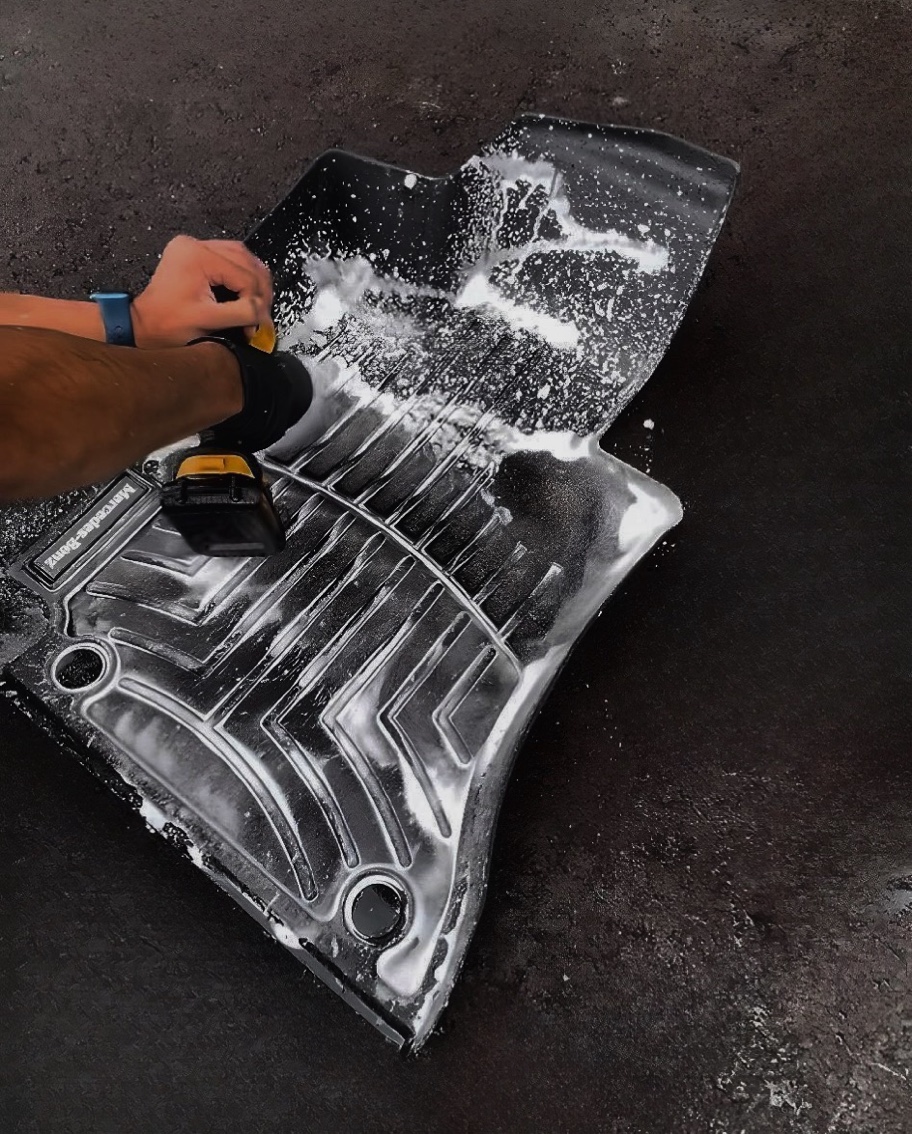 Interior car mat being cleaned with foam to remove all dirt and grime in Croydon